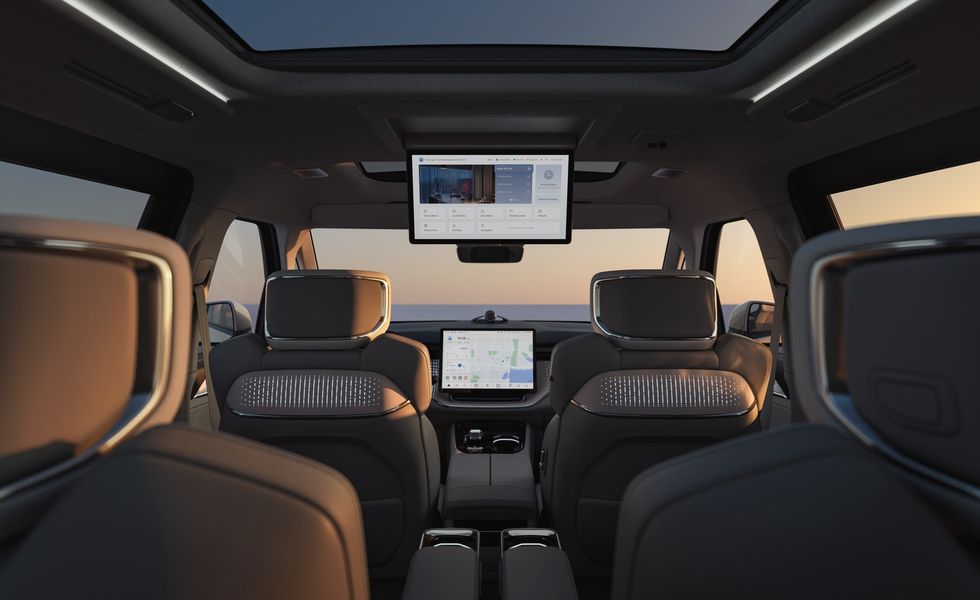 Inside the Volvo EM90's luxurious front cabin with state-of-the-art dashboard and comfortable seating.